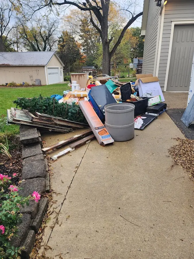 Dumpster being loaded with debris for Estate Cleanout Dumpster Rental in Sparks